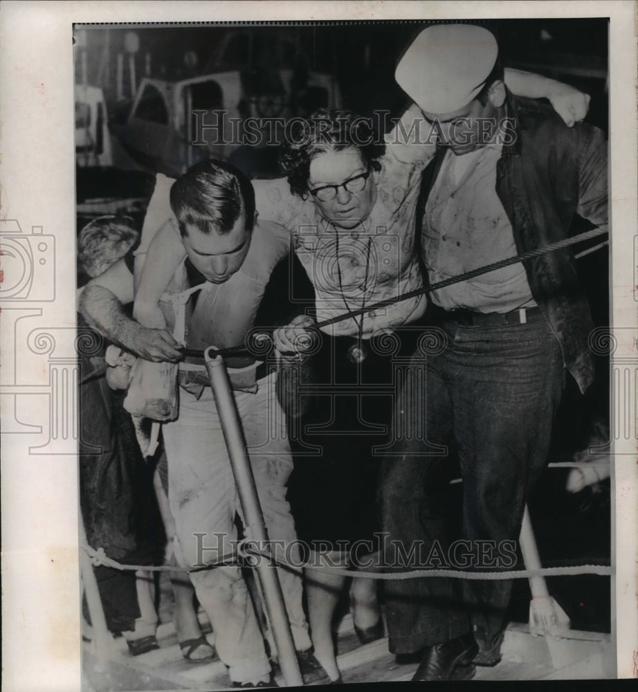 1963 Press Photo A coastguardman and refugee carry ill woman at Key West Florida- Historic Images