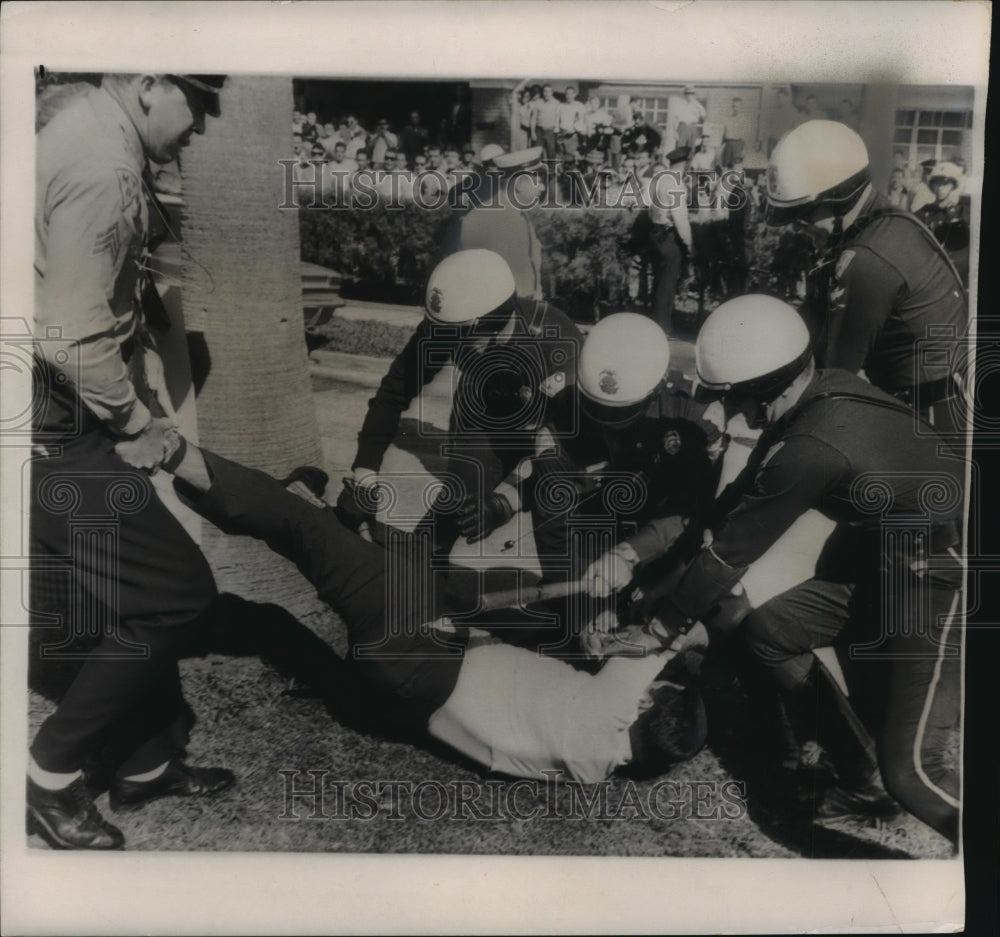 1963 Press Photo Cuban Refugee Restrained During Protests Against Picketers