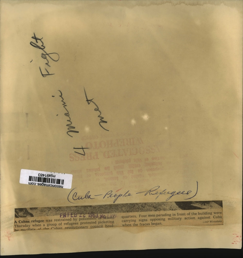 1963 Press Photo Cuban Refugee Restrained During Protests Against Picketers