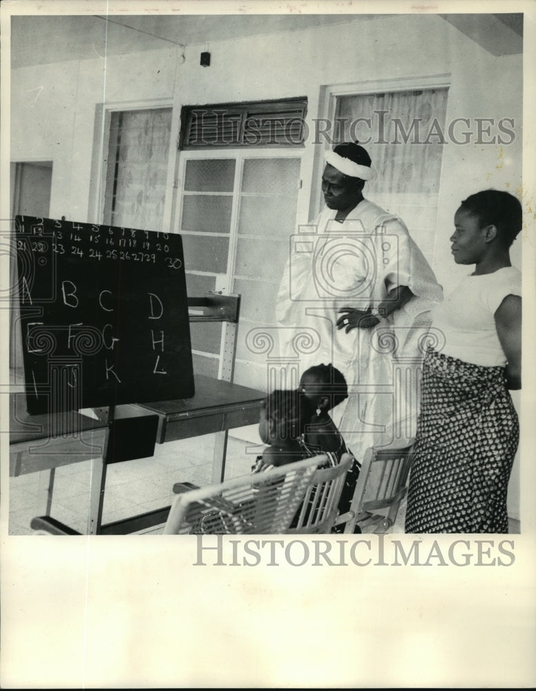 1966 Press Photo Alhaji Haruna Kassim Watches a Governess Tutoring his Children- Historic Images