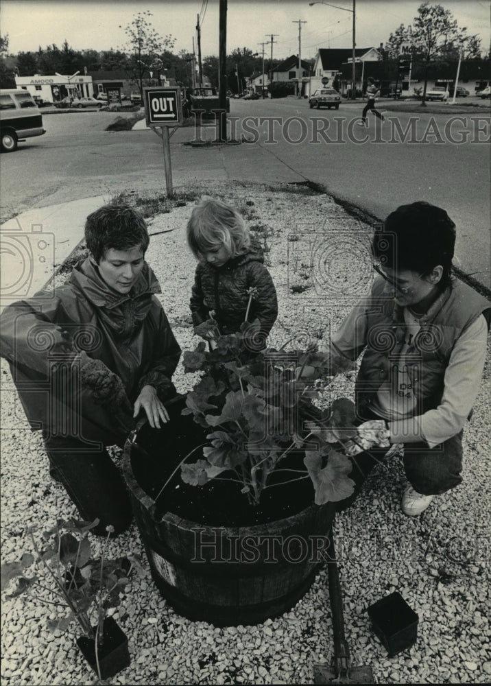 1984 Press Photo Christine and Anna Miller plant flowers in Delafield, Wisconsin- Historic Images