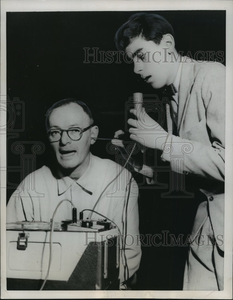 1956 Press Photo John Solem, Fred Kollenkarn testing new hearing aid device.