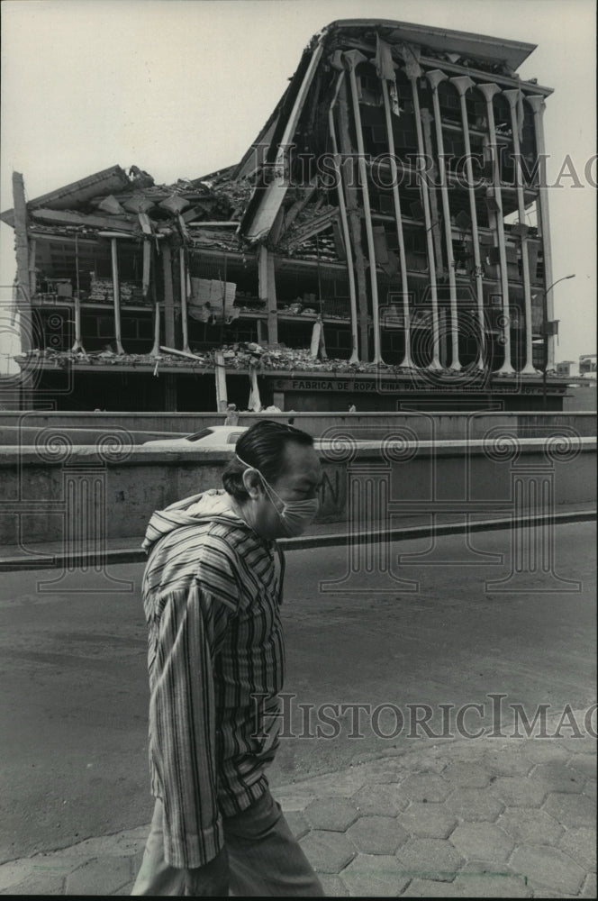 1985 Press Photo A civilian passes a textile factory destroyed in an earthquake- Historic Images