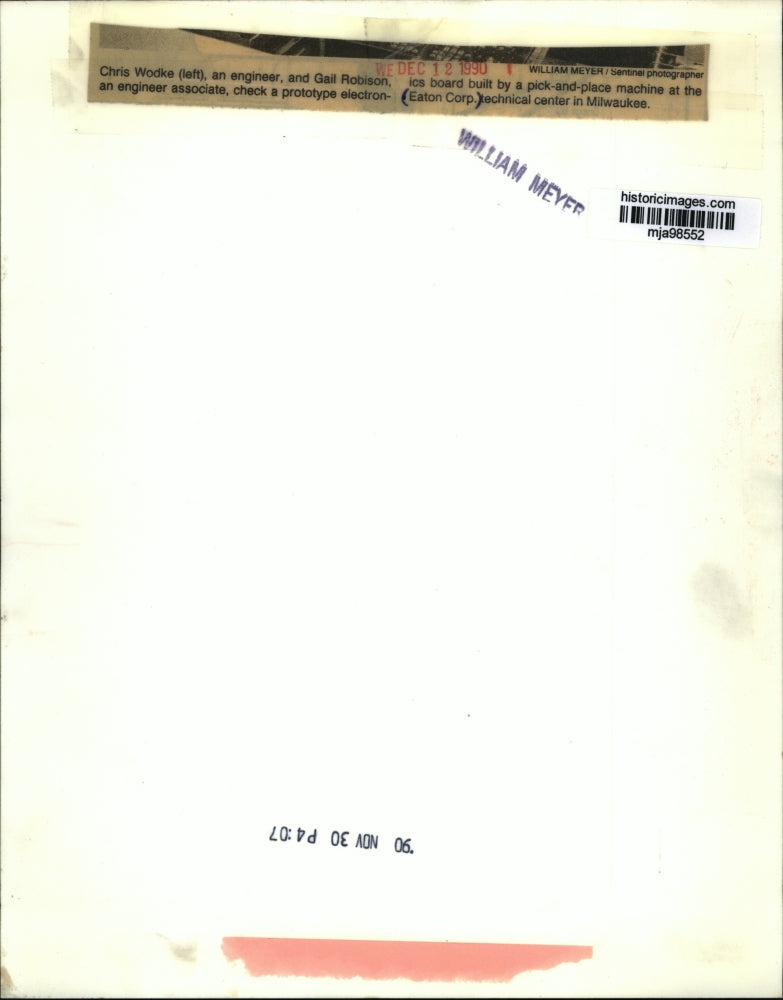 1990 Press Photo Chris Wodke and Gail Robison Check Electronics at Eaton Crop.