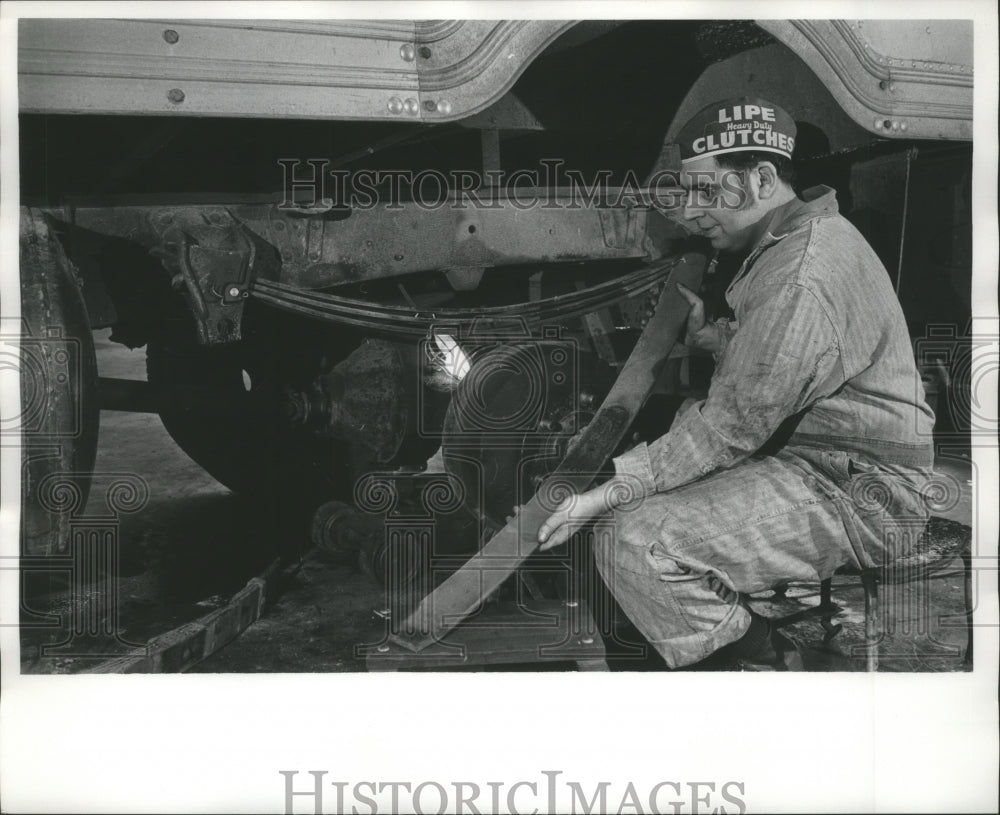 1972 Press Photo Mechanic Looking At Train Part In Need of Repair, 1960s