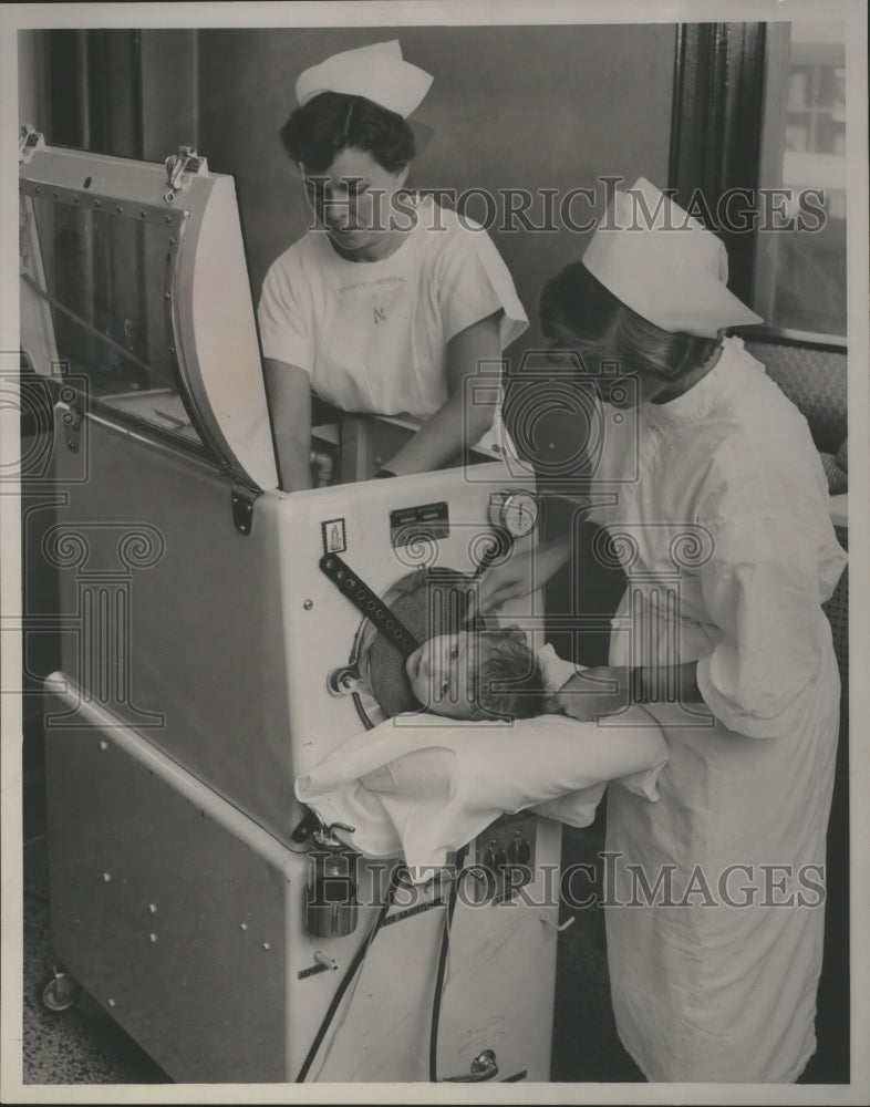 1955 Press Photo Polio patient John Mitchell placed in iron lung in Milwaukee- Historic Images