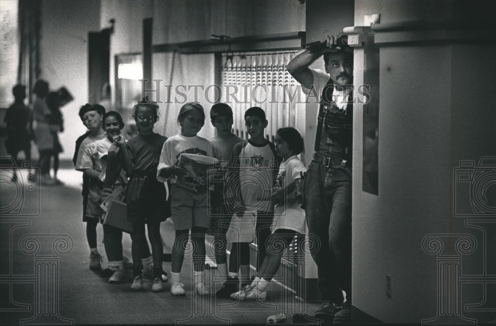 1992 Press Photo Matthew Scwindt Installs Locker Trim at Stormonth School, Wis.