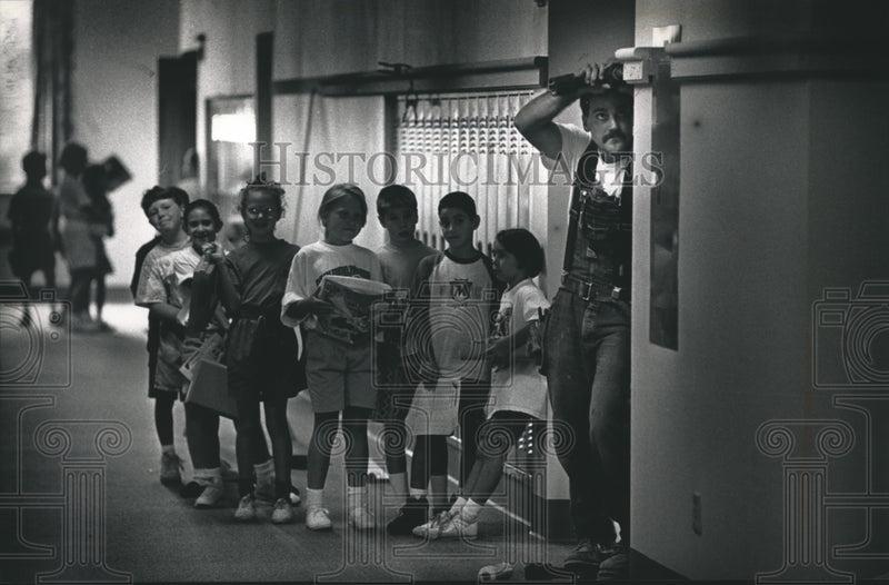 Load image into Gallery viewer, 1992 Press Photo Matthew Scwindt Installs Locker Trim at Stormonth School, Wis.

