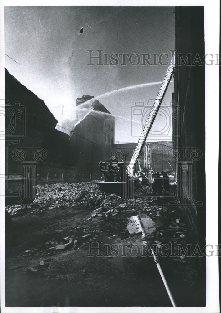 1964 Press Photo Firemen continued to fight fire. - mjb11712- Historic Images