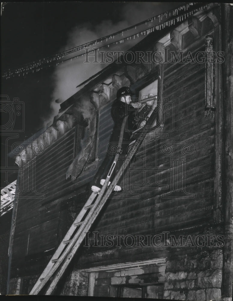 1956 Press Photo Milwaukee Firemen force water into upstairs window of building- Historic Images