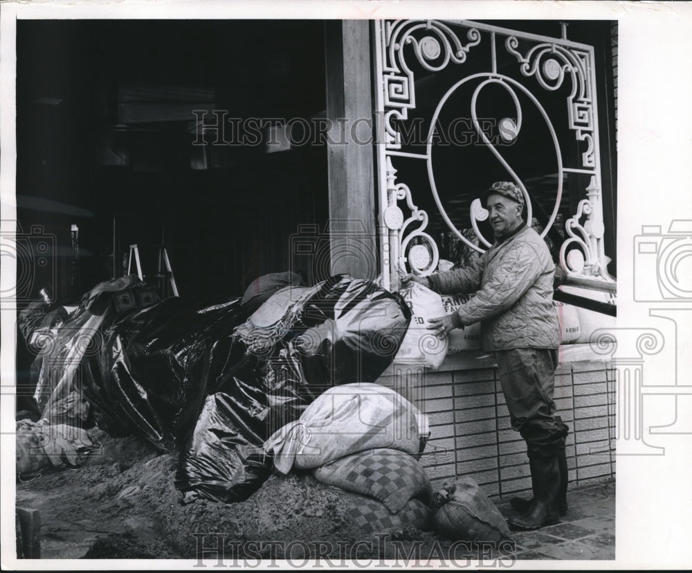 1965 Press Photo Man piles sandbags to protect from floodwaters. - mjb16704- Historic Images