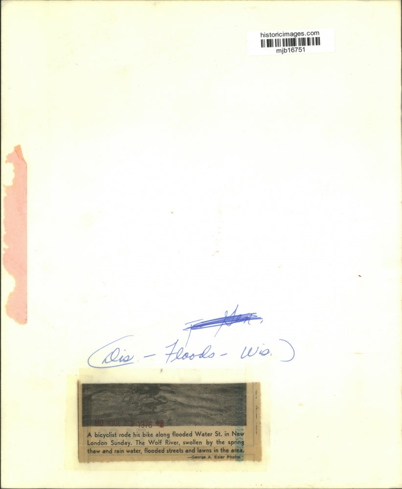 1976 Press Photo A bicyclist rides along flooded Water Street in New London