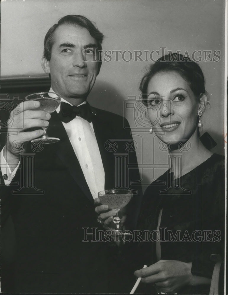 1965 Press Photo Actor Gregory Peck and Wife Toast Yves Saint Laurent- Historic Images