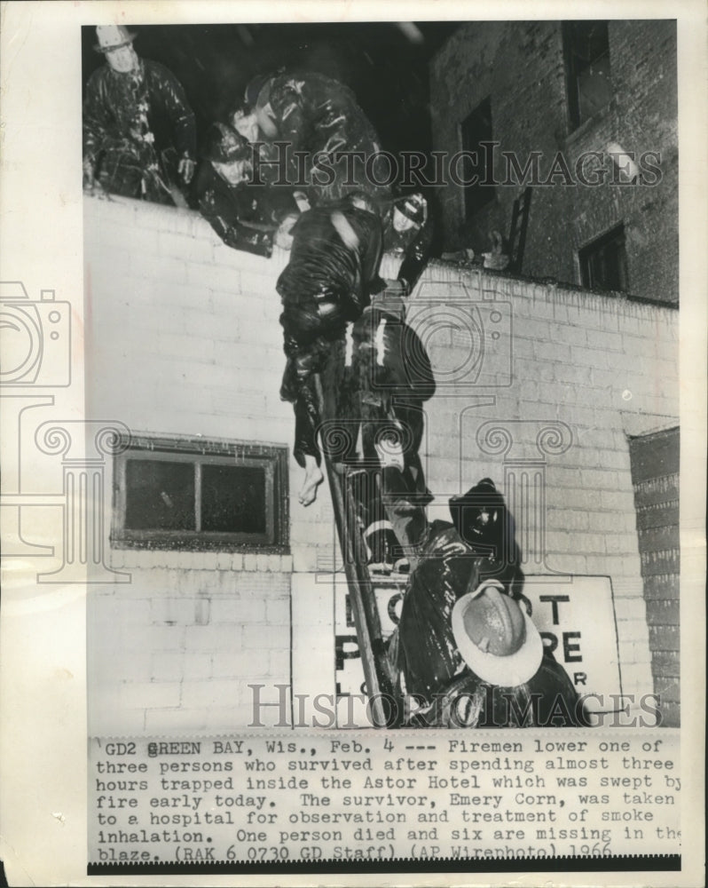 1966 Press Photo Firemen lower a survivor from a blaze in Green Bay, Wisconsin