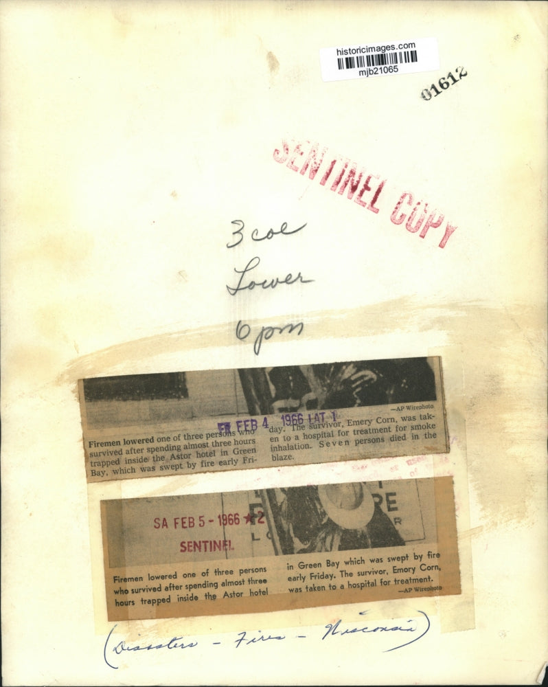 1966 Press Photo Firemen lower a survivor from a blaze in Green Bay, Wisconsin