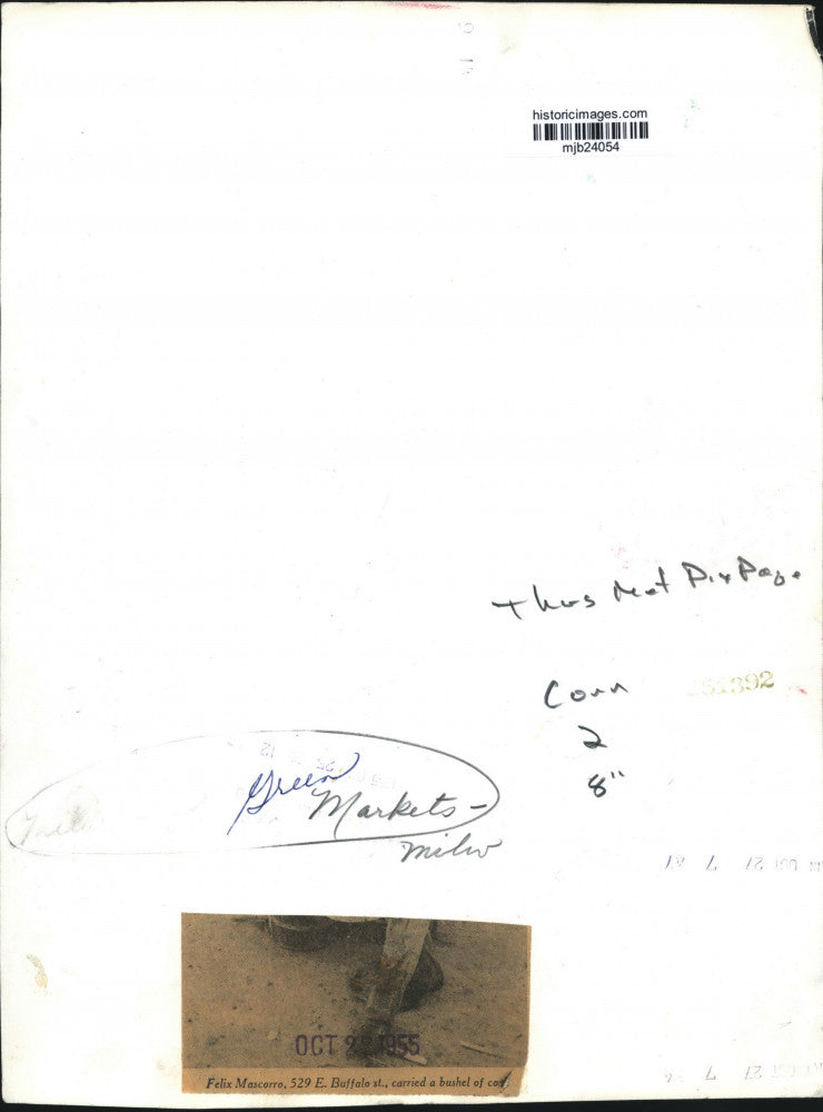 1955 Press Photo Felix Mascorro carries corn, Green Market, Milwaukee