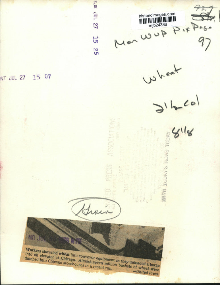 1956 Press Photo Workers shovel wheat from barge into an elevator in Chicago.