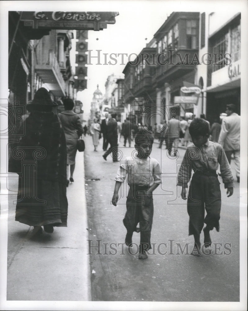 1959 Press Photo Two barefoot boys head home for dinner in Lima, Peru- Historic Images