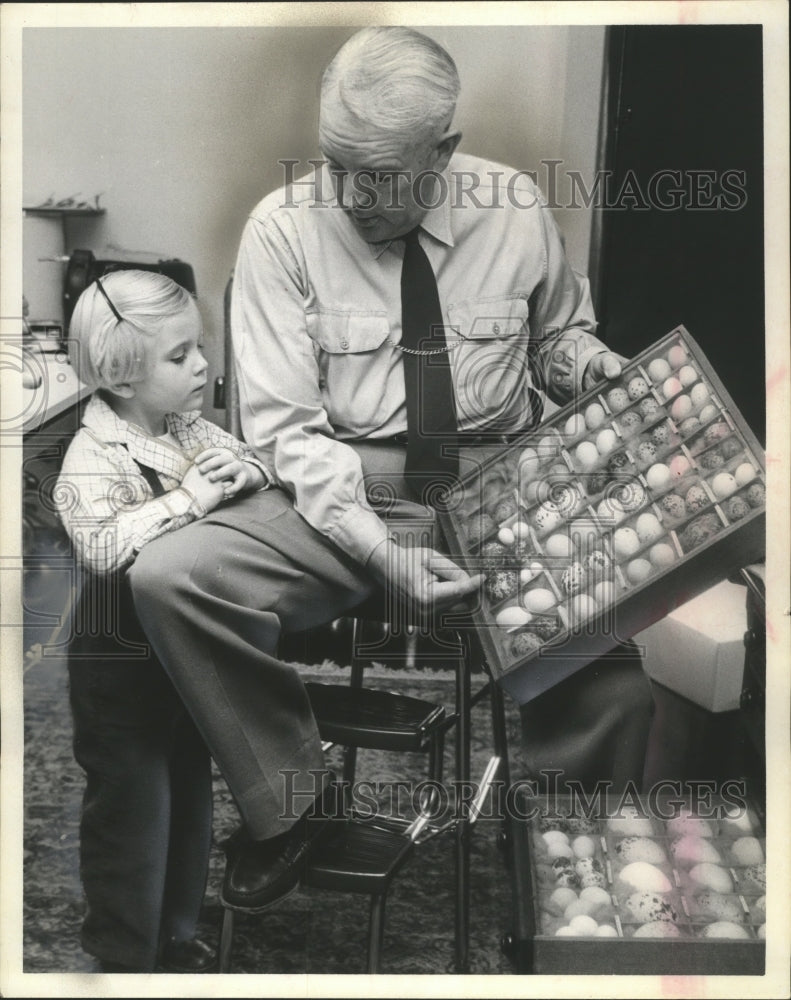 1960 Press Photo Cleveland P. Grant and daughter, look over his egg collection.- Historic Images