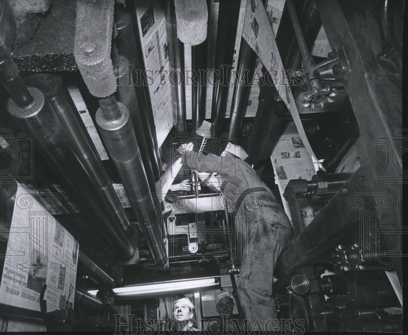 Load image into Gallery viewer, 1960 Press Photo Worker Puts Paper on Press in The Milwaukee Journal Press Room
