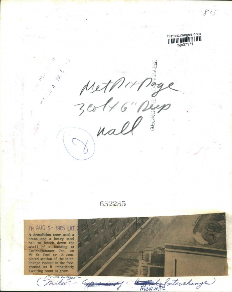 1965 Press Photo Demolition crew knocks down wall of building, Milwaukee.