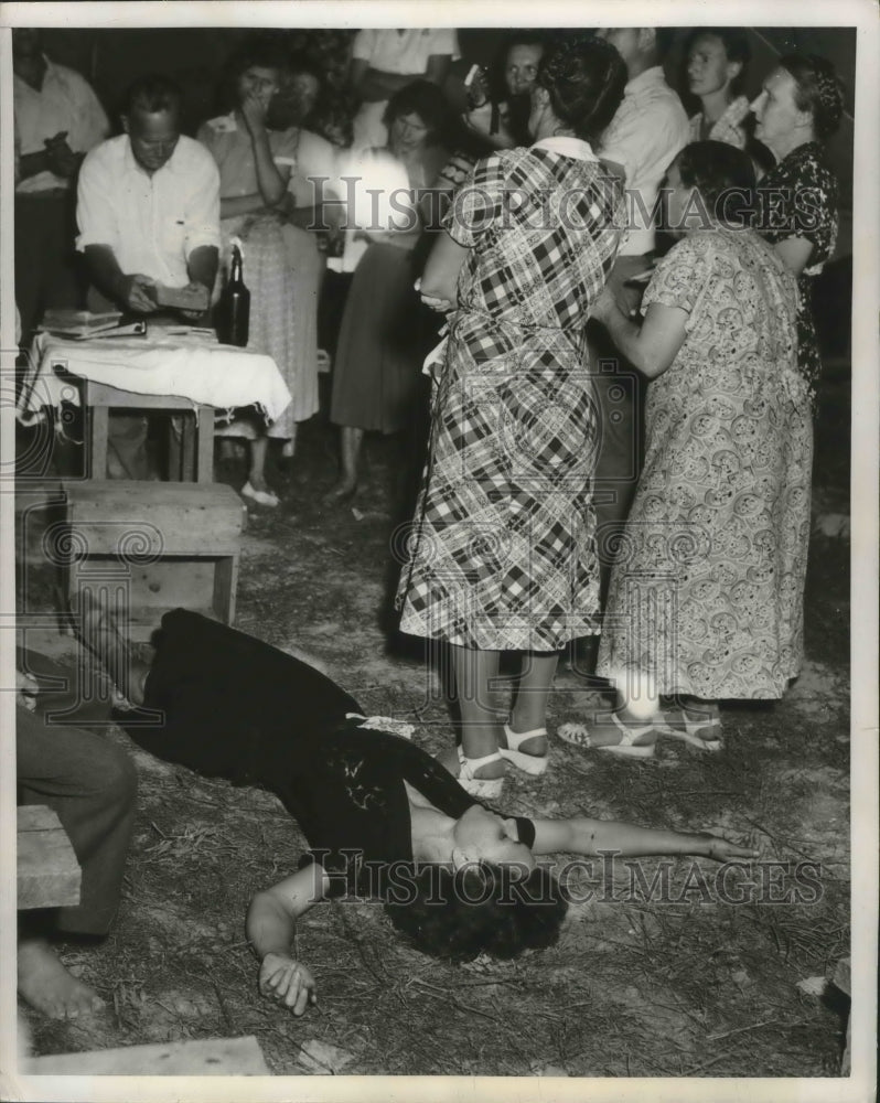 1951 Press Photo A woman faints after demonstrating her faith- Historic Images