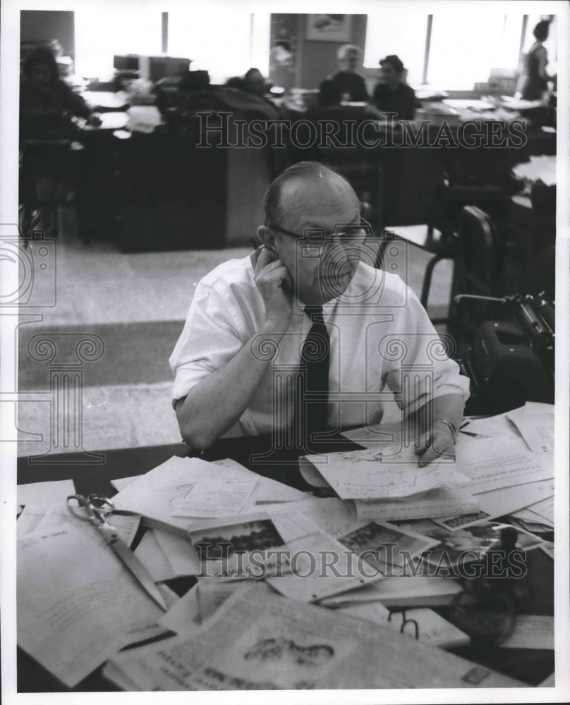 1957 Press Photo Milwaukee Journal employee at his desk in Feature Department