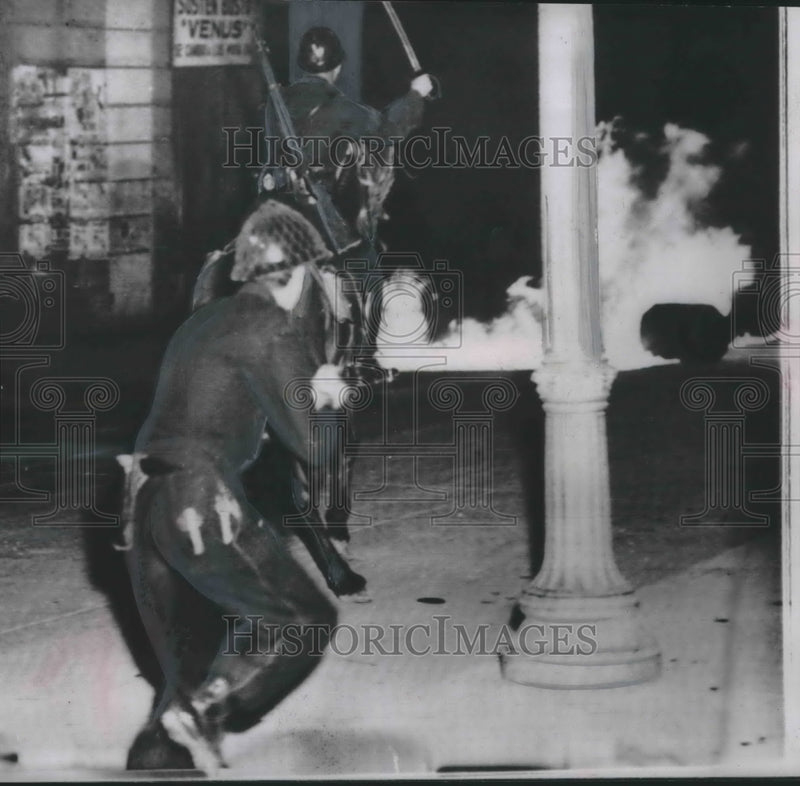 Load image into Gallery viewer, 1952 Press Photo Mexican policeman and soldier charging Mexican rioters
