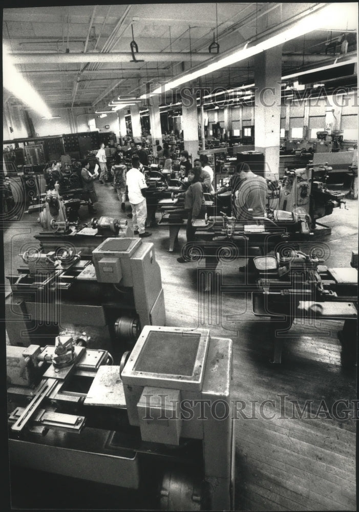 Load image into Gallery viewer, 1993 Press Photo Teacher Nou Vang instructs students in machine shop, Milwaukee.
