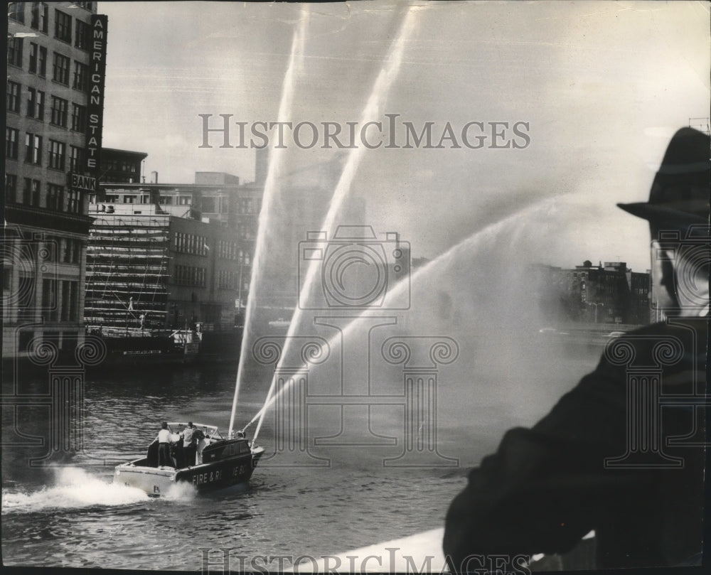 1962 Press Photo Stream of water flow from fire boat on the Milwaukee river.