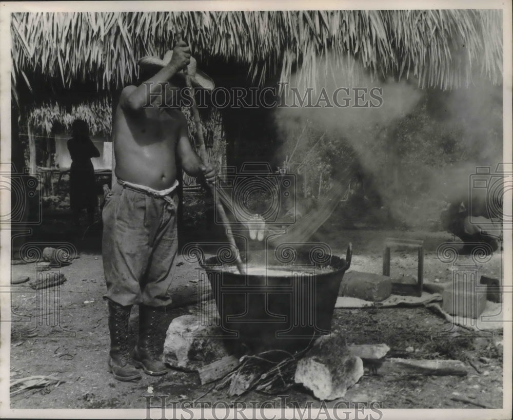 1954 Press Photo man boils water harvest in small village - mjb49184