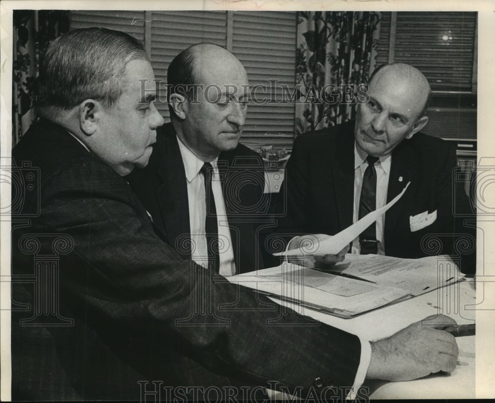 1964 Press Photo Businessmen review North Western road price for county board