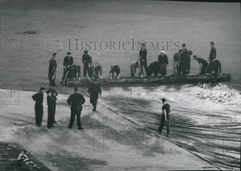 1953 Press Photo Umpires inspect infield after rain delay, Milwaukee Stadium