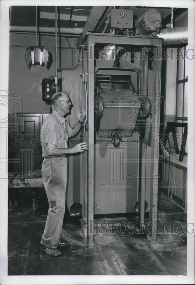 1958 Press Photo Employee operating machinery in his department.- Historic Images