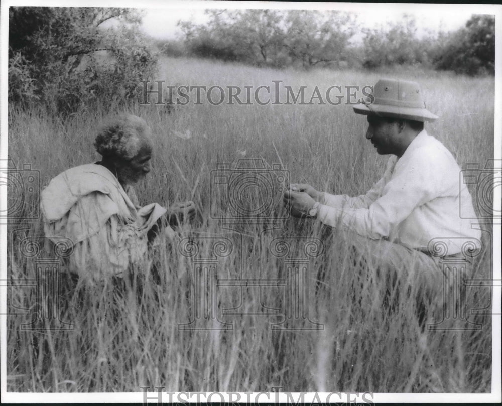 1964 Press Photo Villager with Range Management Officer in grass, Pakistan