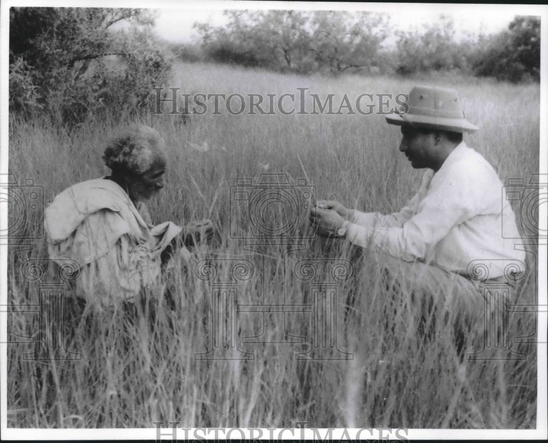 Load image into Gallery viewer, 1964 Press Photo Villager with Range Management Officer in grass, Pakistan
