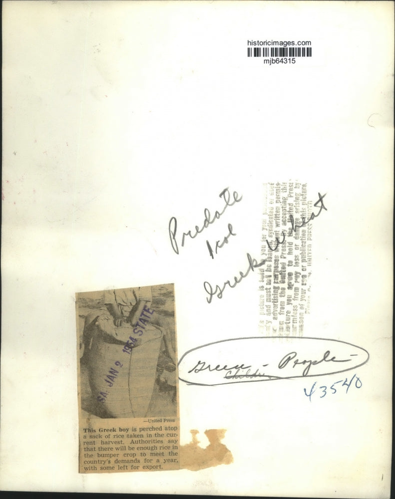 1954 Press Photo Greece, boy atop a sack of rice taken in current harvest.