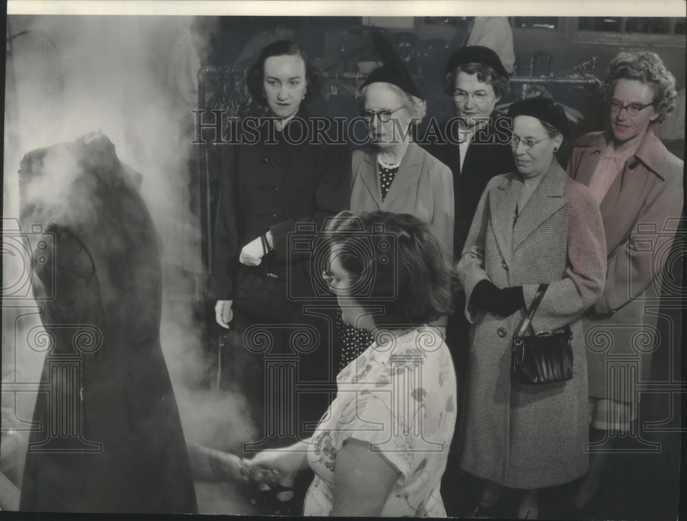 1951 Press Photo Worker at Goodwill open house demonstrates a garment steamer- Historic Images