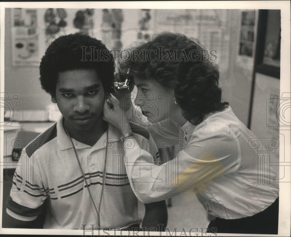 1988 Press Photo Nurse Vicki Mattias examines South Division High School student- Historic Images