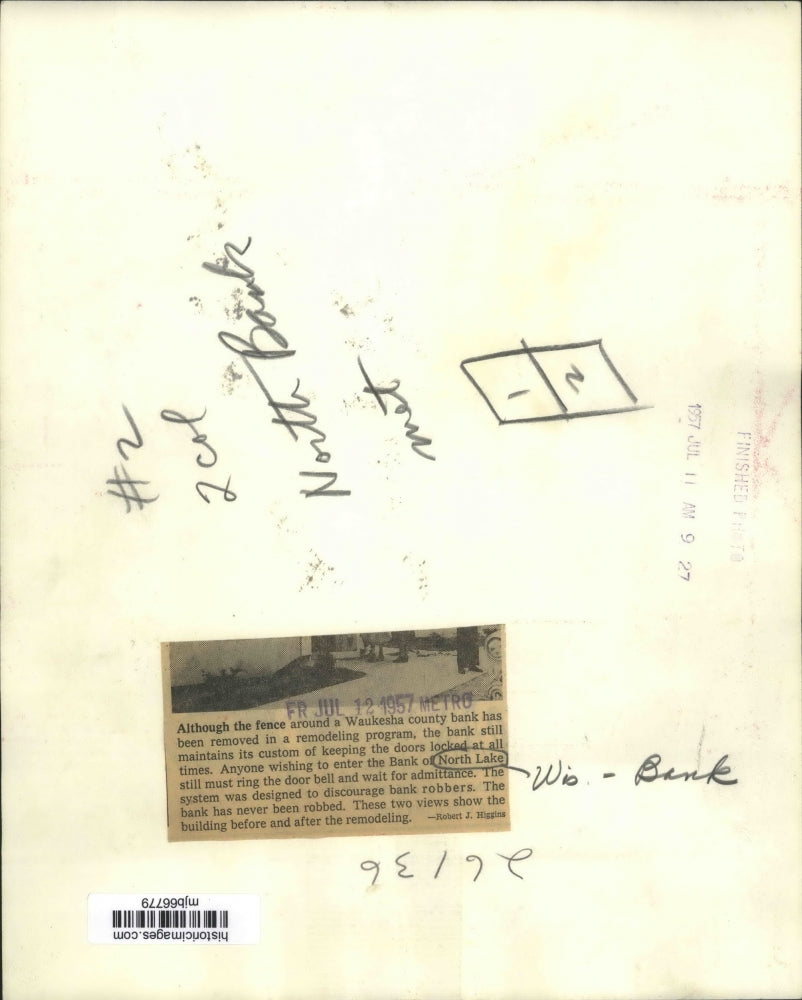 1957 Press Photo Fence at Waukesha county bank removed in a remodeling program