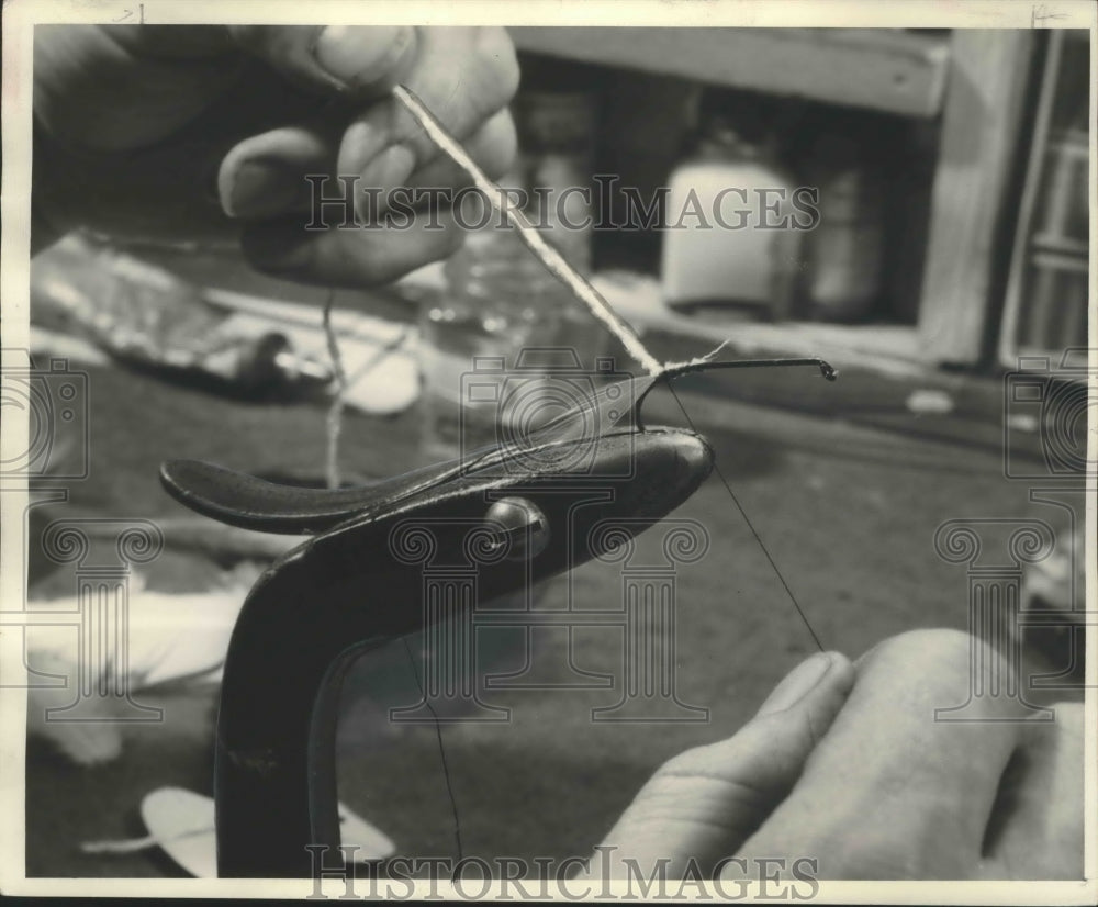 1950 Press Photo Wrapping body of fly on fishing hook - mjb67906
