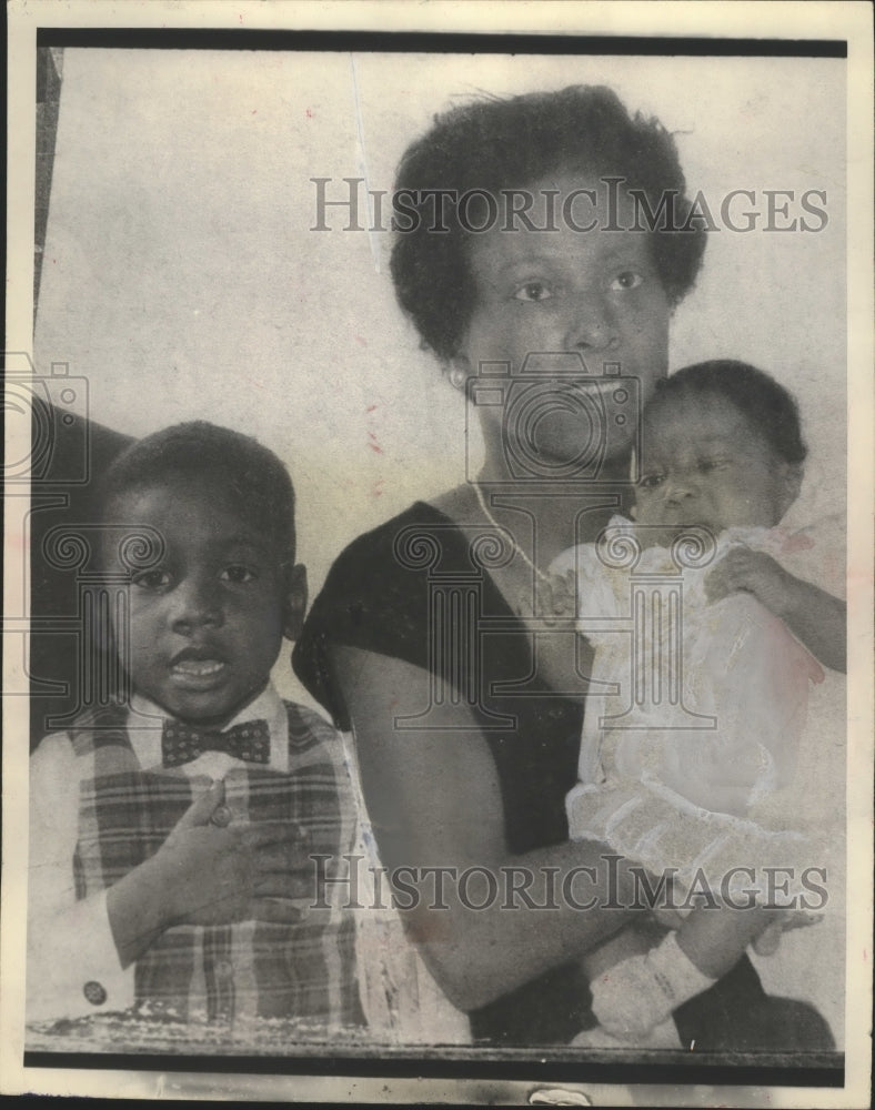  Press Photo A mother holds her baby and sits with her young son- Historic Images