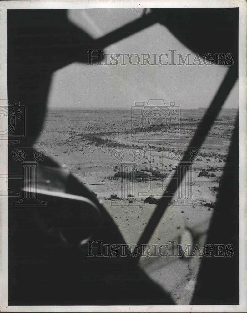 1953 Press Photo Aerial view of pilot in plane dropping newspapers at ranches.