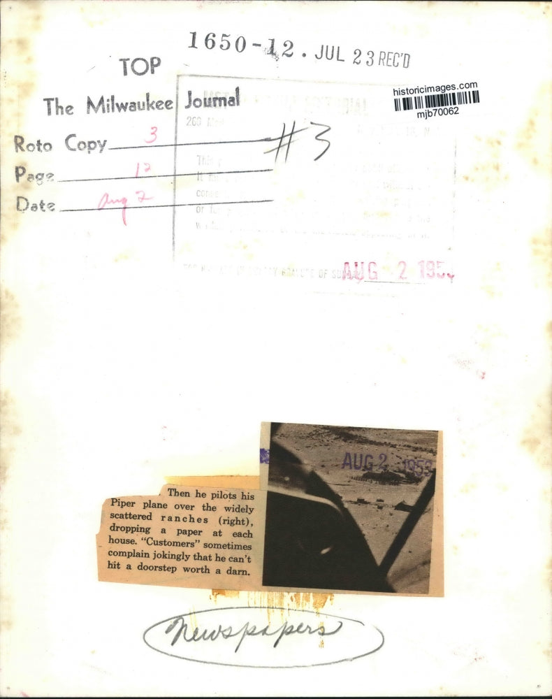 1953 Press Photo Aerial view of pilot in plane dropping newspapers at ranches.