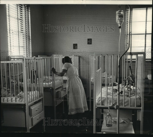 1960 Press Photo Mrs. Arlene Belmore supervisor, with babies in cribs, Wisconsin