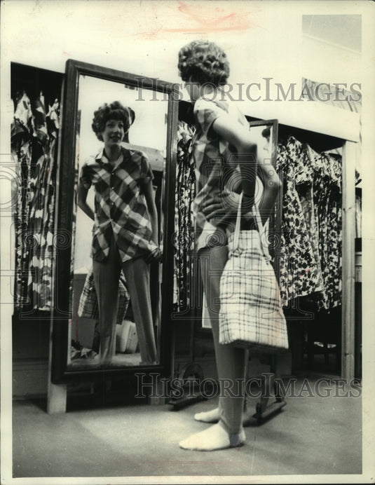 1965 Press Photo Anne Rowston admires her figure in a London store - mjb80091- Historic Images