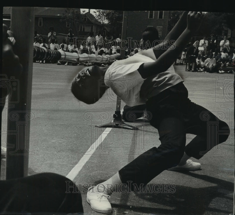 Load image into Gallery viewer, 1964 Press Photo Victor Bell limbos. Lloyd St School Physical Fitness Festival
