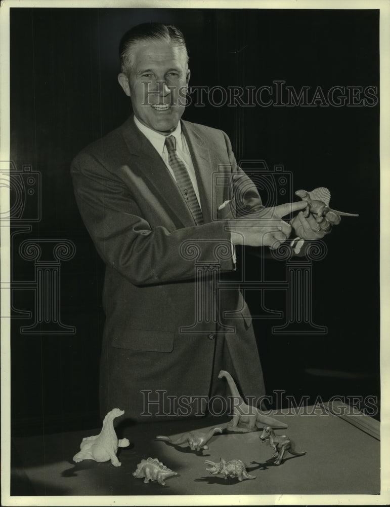 1957 Press Photo George Romney shows a variety of dinosaur figures - mjb87190- Historic Images