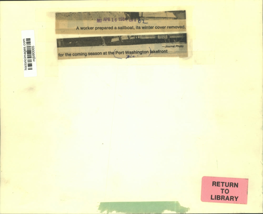 1984 Press Photo Worker prepares boat for season, Port Washington lakefront