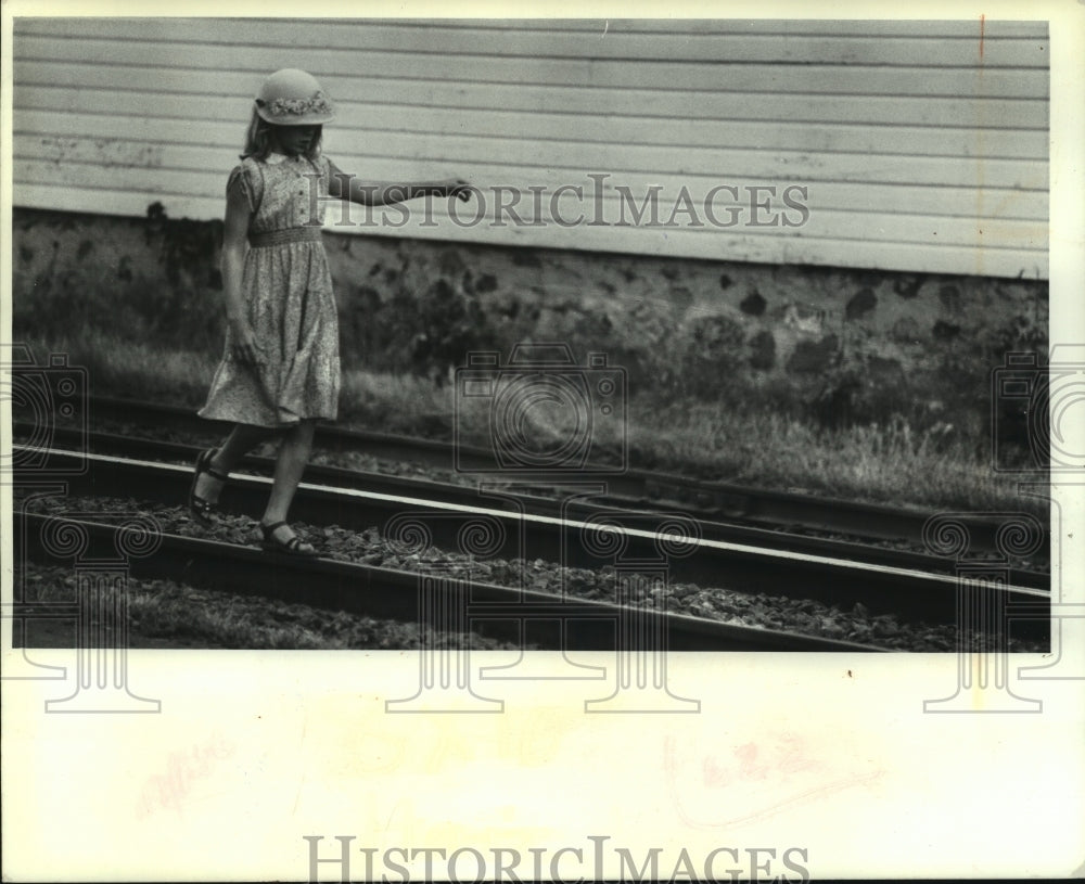  Press Photo Young girl strolls down the railroad tracks in Stanley, Wisconsin- Historic Images